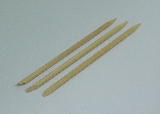 Sticks of orange wood for manicure